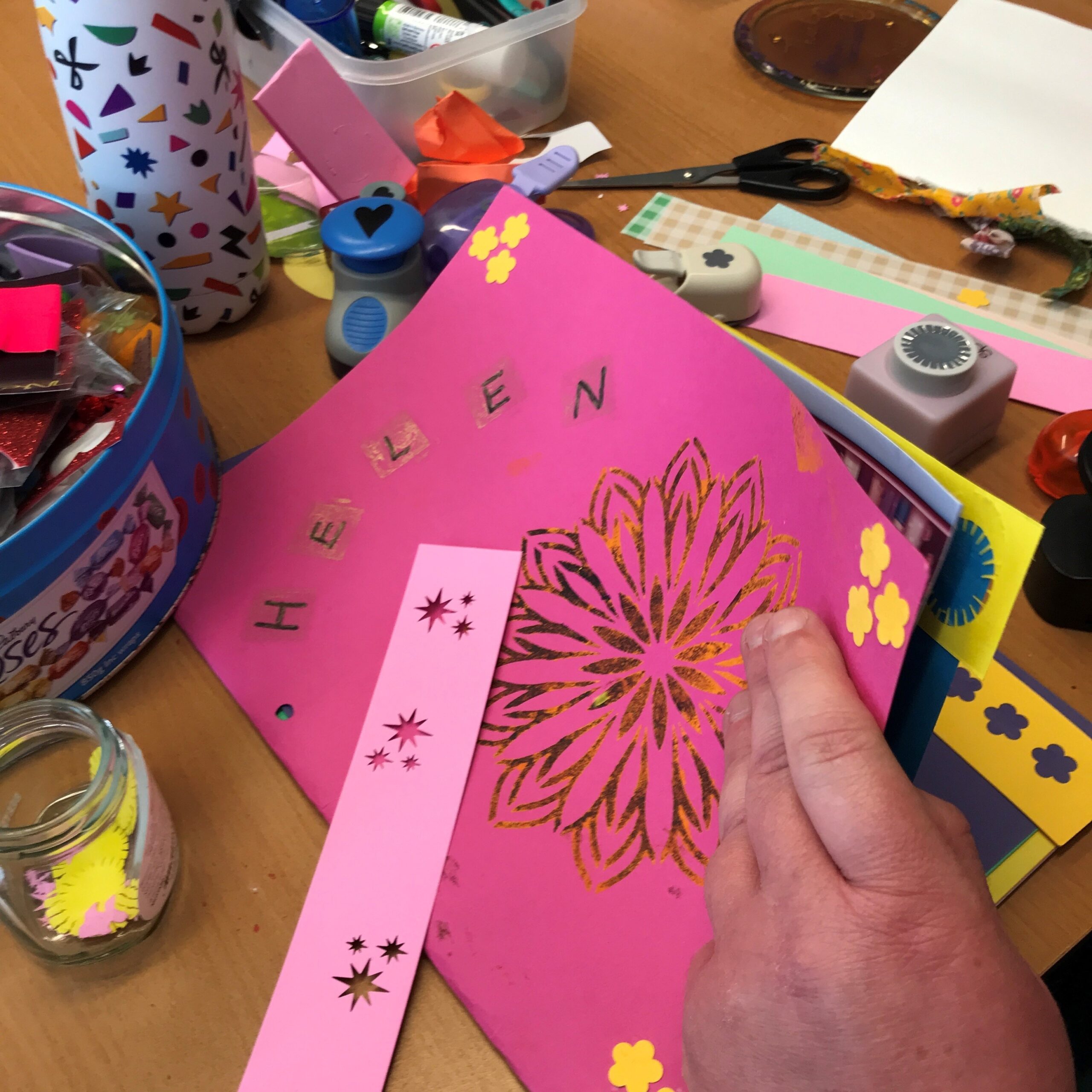 Someones hand opening a scrapbook