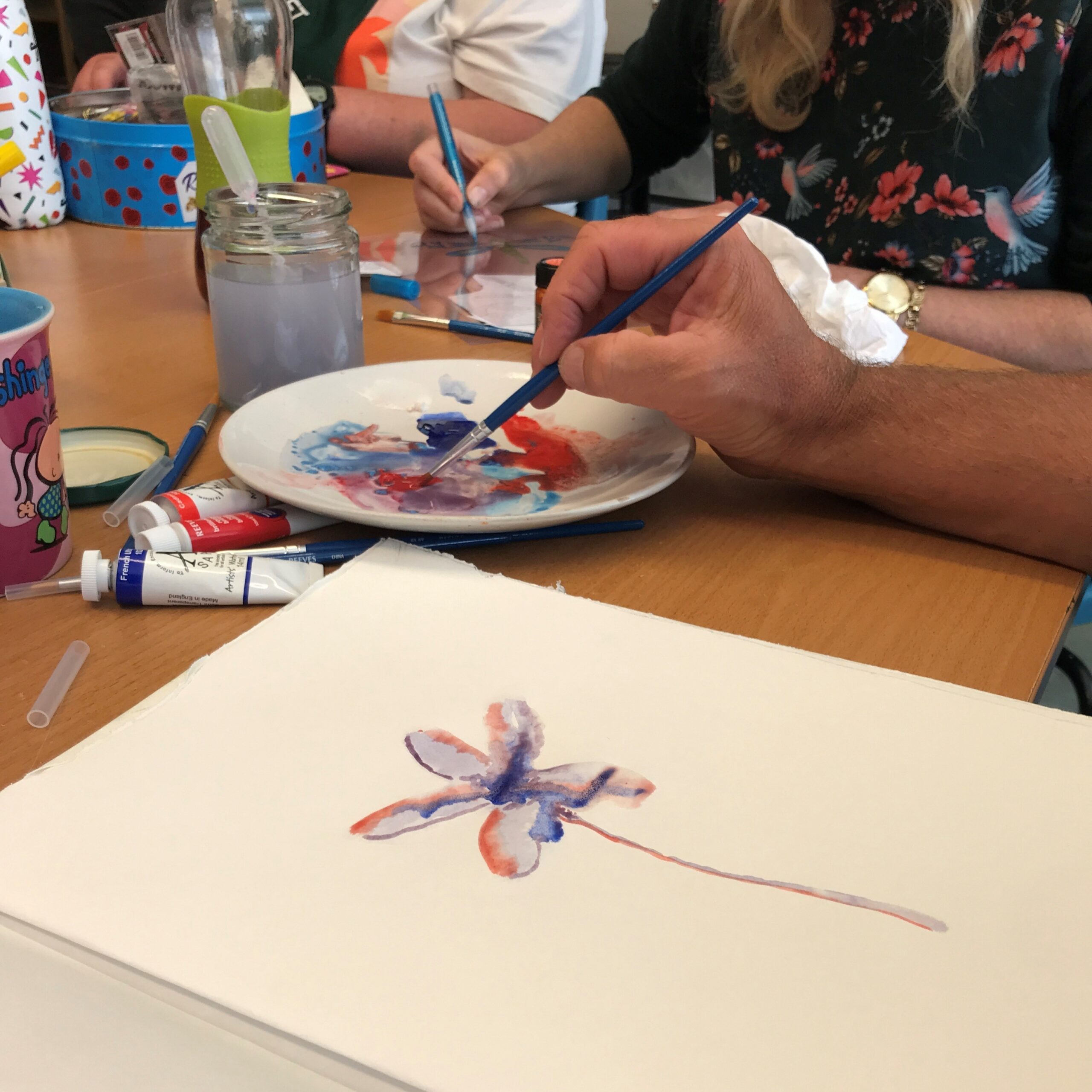 Someone painting a flower