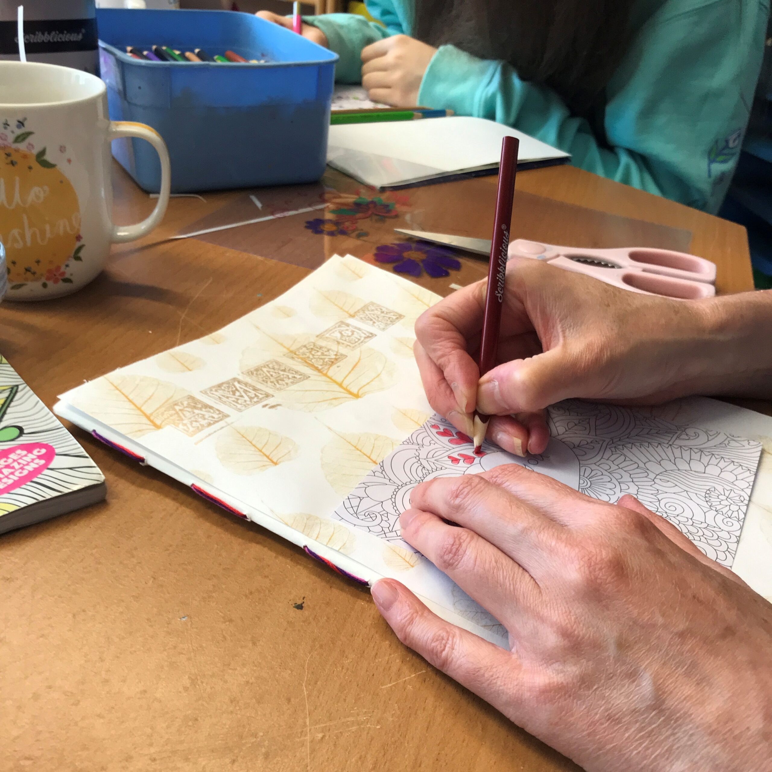 Someone colouring in a colouring book