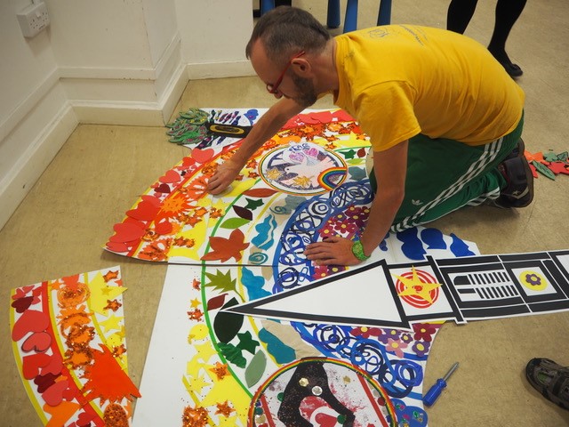 Someone painting a picture on the floor
