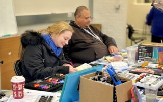 Two participants working on their artwork