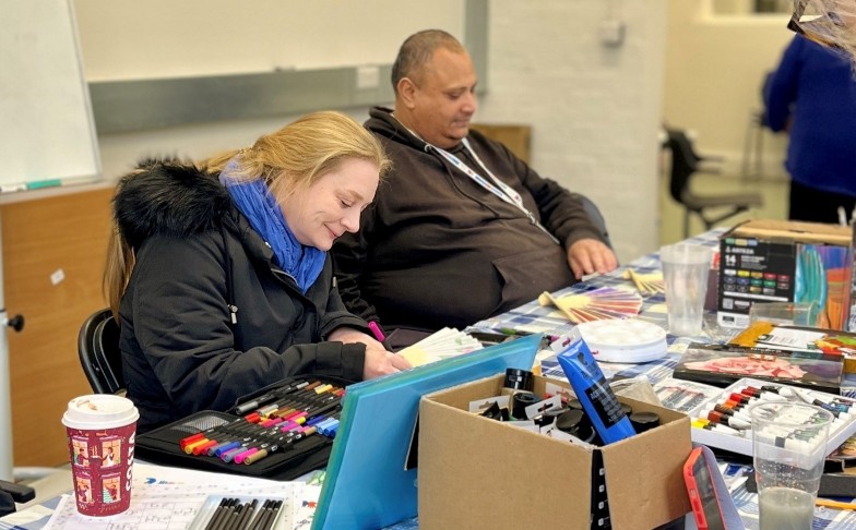 Creating-history-news-hero Two participants working on their artwork